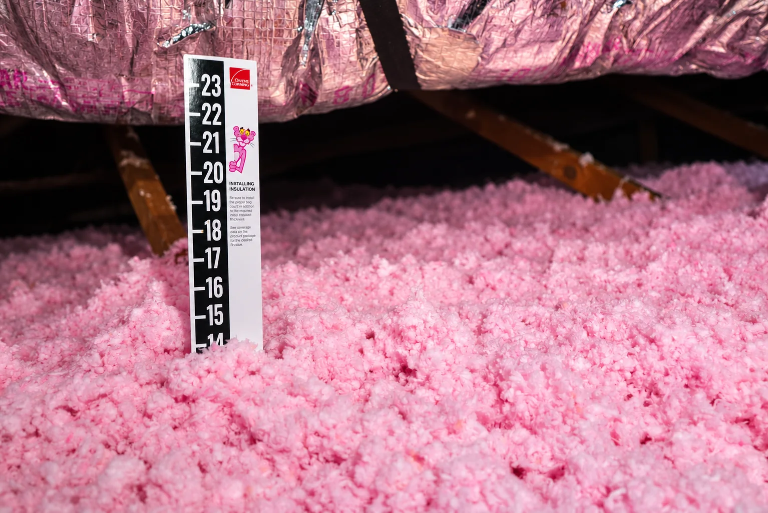 Depth marker showing insulation coverage in an attic